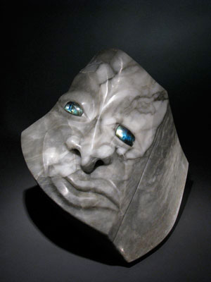 The Great Grey Face is a fine art sculpture in rare grey Alabaster stone that hides a precious container and is inlaid with labradorite eyes.