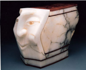 Carved face in white Alabaster with Brazilian Agate Eyes and juniper burl.