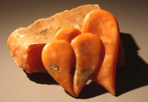 Orange heart shaped alabaster containers carved in hand gathered stone from Bryce Canyon, Utah and lined with high desert juniper.