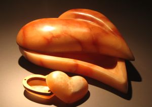 Orange heart shaped alabaster containers carved in hand gathered stone from Bryce Canyon, Utah and lined with high desert juniper.